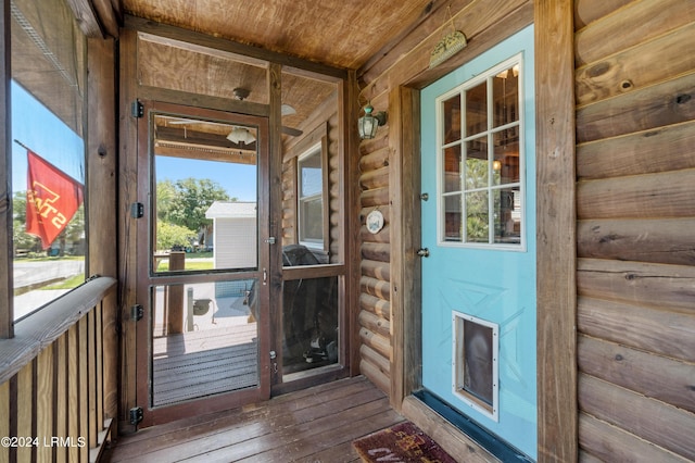 entryway featuring hardwood / wood-style flooring, wooden walls, wooden ceiling, and rustic walls