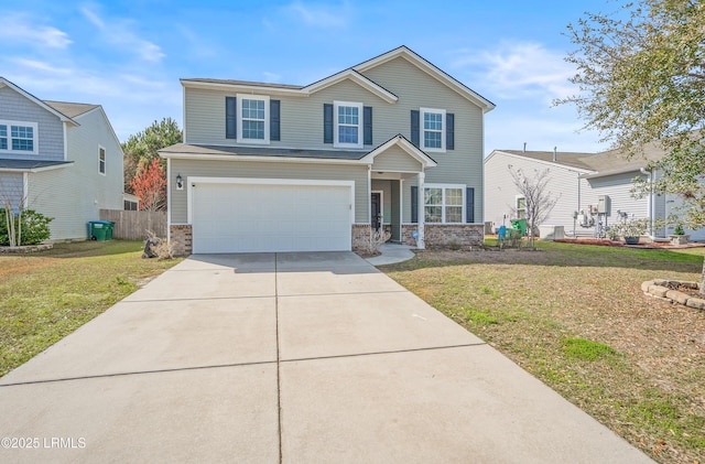 view of front of house with brick siding, concrete driveway, a front yard, fence, and a garage