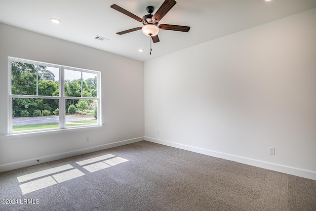 carpeted spare room with ceiling fan