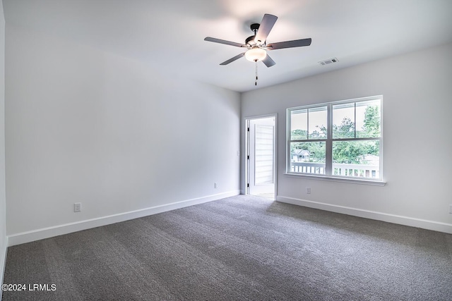 carpeted spare room with ceiling fan