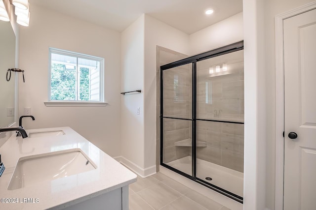 bathroom featuring tile patterned flooring, vanity, and a shower with shower door