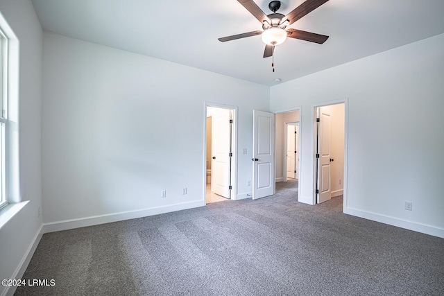 unfurnished bedroom with ceiling fan, ensuite bath, and carpet