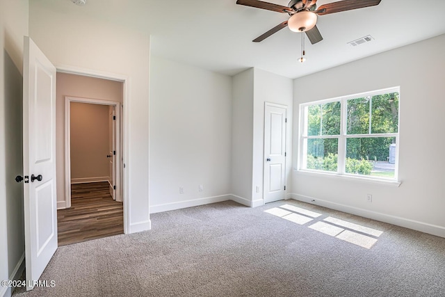 unfurnished bedroom with ceiling fan and carpet