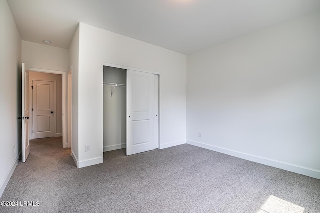 unfurnished bedroom with carpet floors and a closet