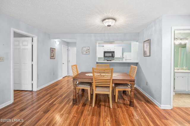 1231 Ladys Island Dr Unit 327, Port Royal, SC 29935 - dining room featuring wood finished floors and a textured ceiling