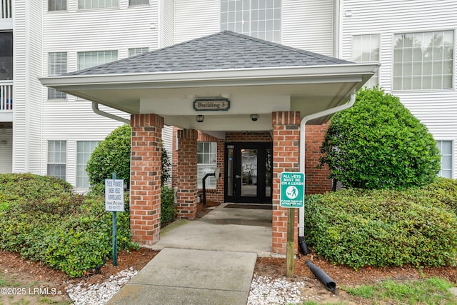 1231 Ladys Island Dr Unit 327, Port Royal, SC 29935 - doorway to property with roof with shingles and brick siding