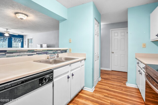 1231 Ladys Island Dr Unit 327, Port Royal, SC 29935 - kitchen with white dishwasher, light wood-type flooring, white cabinetry, light countertops, and a textured ceiling