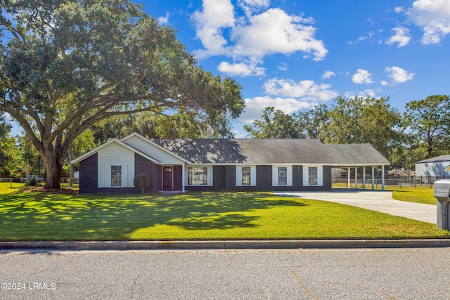 single story home featuring a carport and a front yard