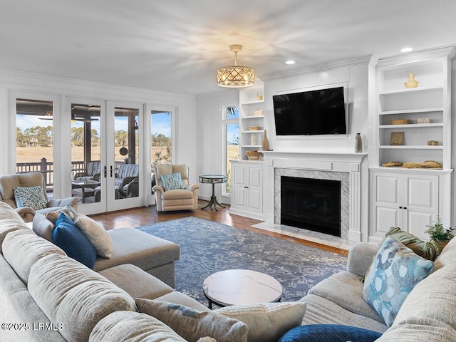31 Hearthwood Dr, Hilton Head Island, SC 29928 - living room featuring a high end fireplace, crown molding, wood finished floors, and built in shelves