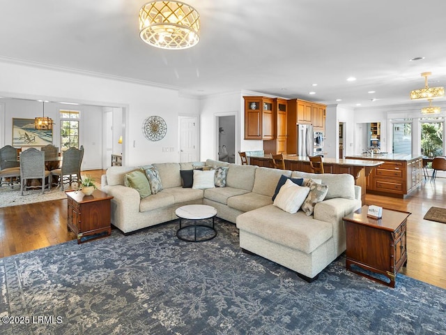 31 Hearthwood Dr, Hilton Head Island, SC 29928 - living area featuring an inviting chandelier, recessed lighting, crown molding, and wood finished floors