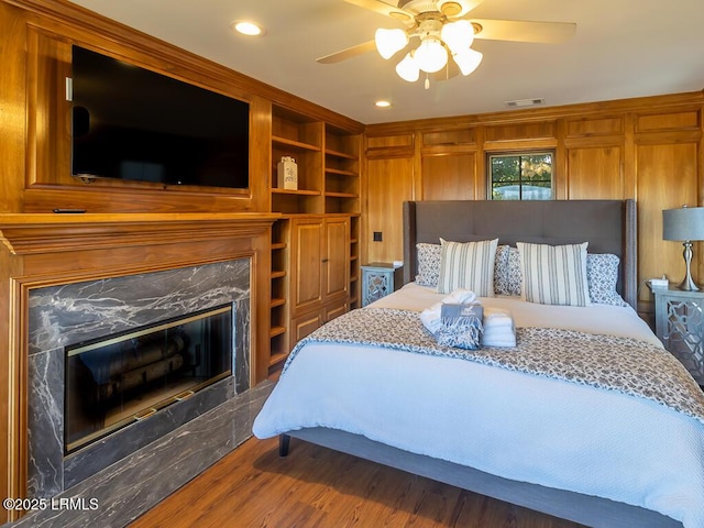 31 Hearthwood Dr, Hilton Head Island, SC 29928 - bedroom featuring wood finished floors, a high end fireplace, visible vents, ceiling fan, and recessed lighting