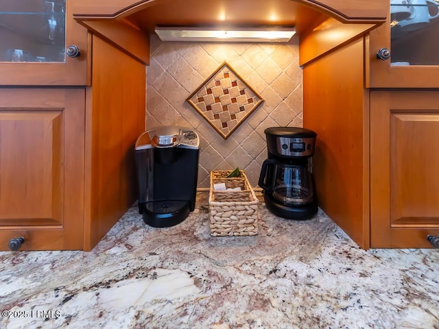 31 Hearthwood Dr, Hilton Head Island, SC 29928 - interior details featuring glass insert cabinets, tasteful backsplash, and light stone counters