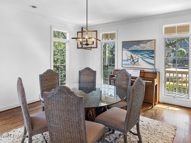 31 Hearthwood Dr, Hilton Head Island, SC 29928 - dining space with crown molding, a notable chandelier, and hardwood / wood-style flooring