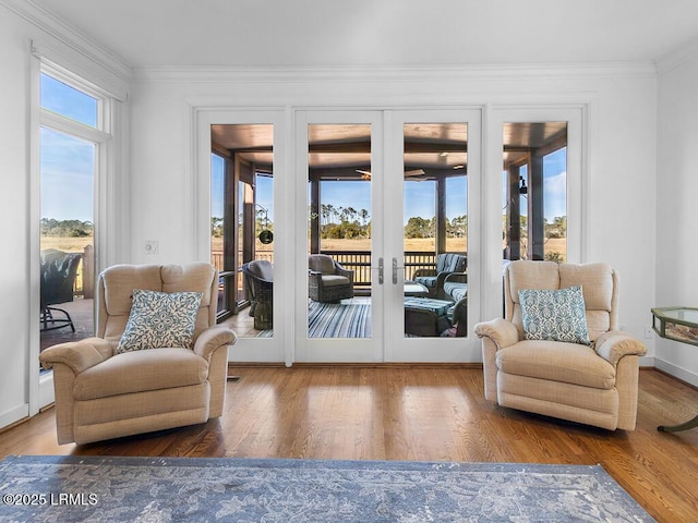 31 Hearthwood Dr, Hilton Head Island, SC 29928 - sitting room with wood finished floors, ornamental molding, french doors, and a healthy amount of sunlight