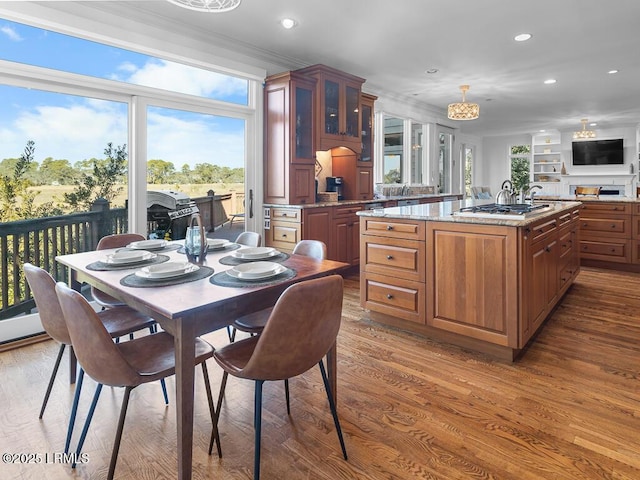 31 Hearthwood Dr, Hilton Head Island, SC 29928 - kitchen with recessed lighting, ornamental molding, glass insert cabinets, and wood finished floors
