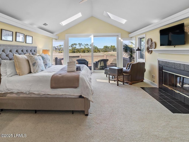 31 Hearthwood Dr, Hilton Head Island, SC 29928 - bedroom featuring carpet flooring, visible vents, vaulted ceiling with skylight, a tiled fireplace, and access to exterior