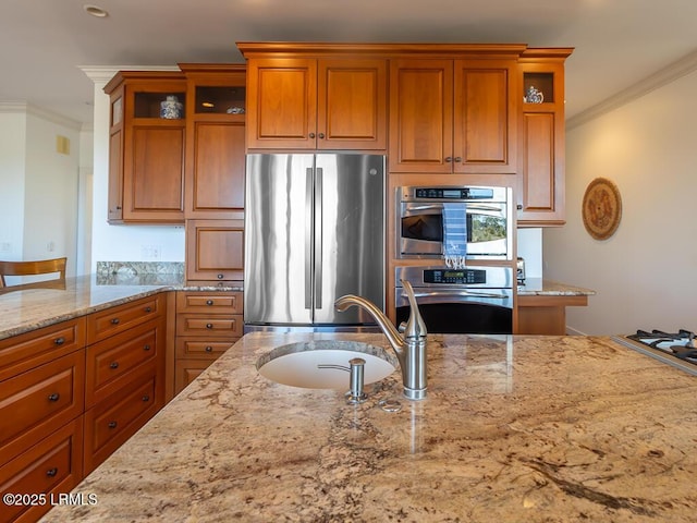 31 Hearthwood Dr, Hilton Head Island, SC 29928 - kitchen featuring light stone counters, a sink, brown cabinetry, stainless steel appliances, and ornamental molding
