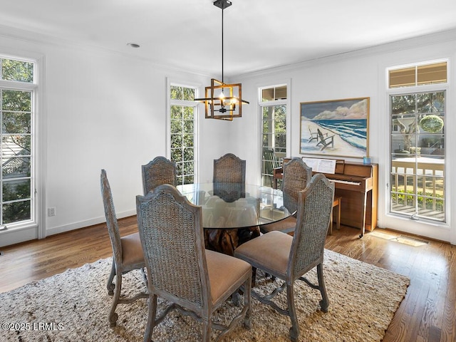 31 Hearthwood Dr, Hilton Head Island, SC 29928 - dining area featuring baseboards, ornamental molding, wood finished floors, and a chandelier