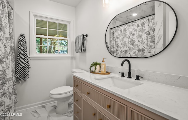 bathroom featuring marble finish floor, baseboards, vanity, and toilet