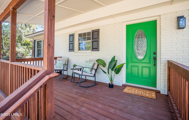 view of exterior entry featuring brick siding