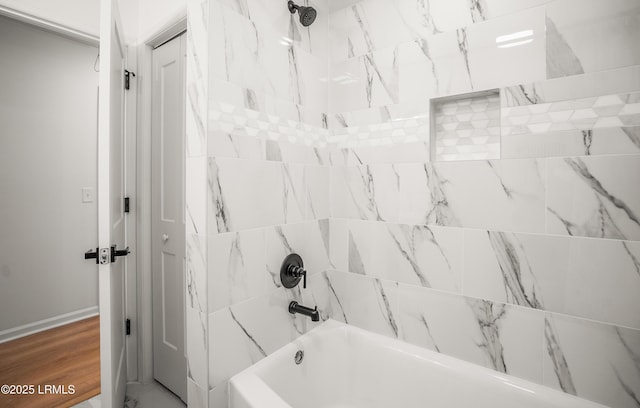 bathroom with bathtub / shower combination and wood finished floors