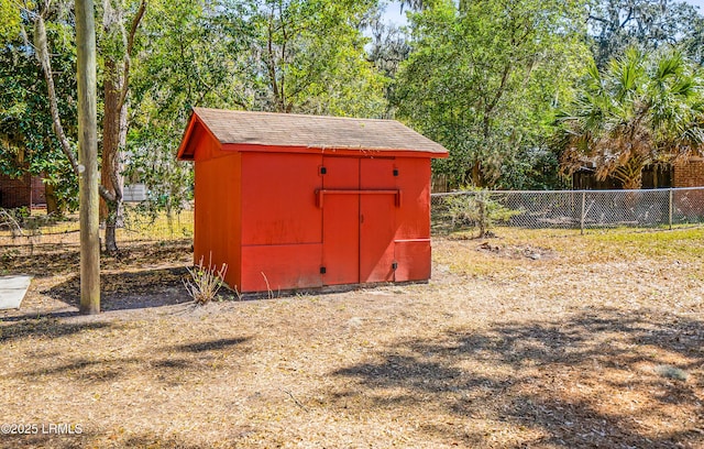 view of shed featuring fence