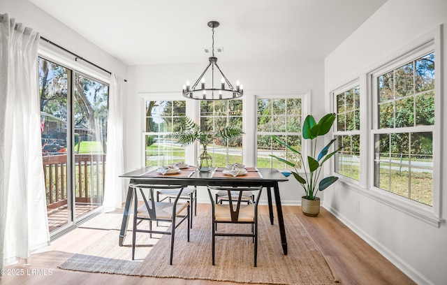 sunroom / solarium with a chandelier and visible vents