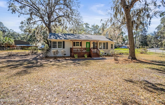 ranch-style house featuring fence and a chimney