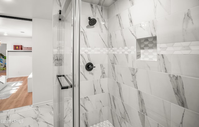 full bath featuring marble finish floor and a shower stall