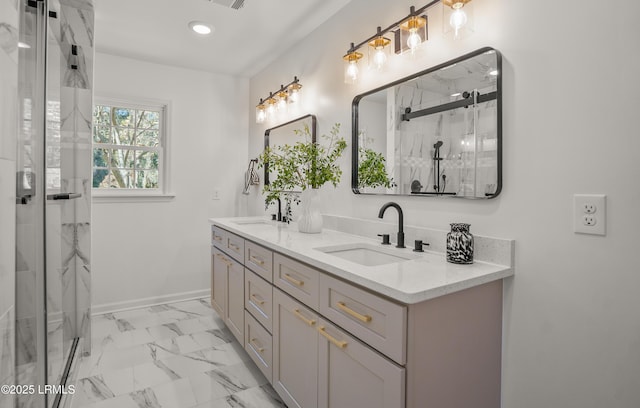 full bath with marble finish floor, a sink, a shower stall, and double vanity