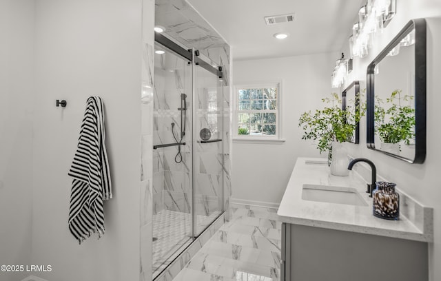 full bath with marble finish floor, a marble finish shower, visible vents, and a sink