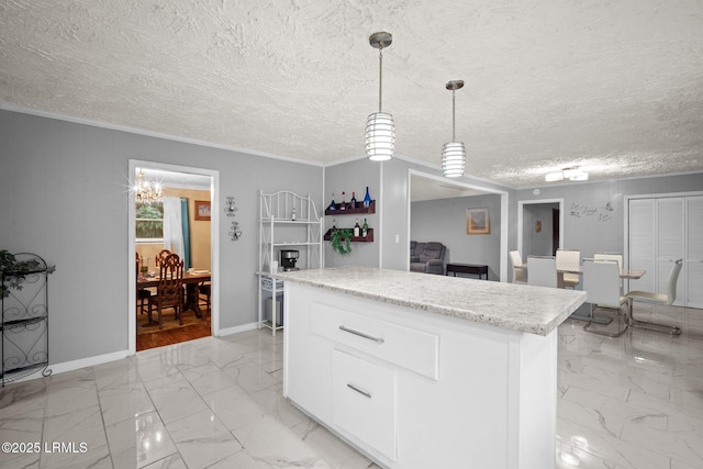 21 River Rd, Yemassee, SC 29945 - kitchen featuring light marble finish flooring, white cabinets, a kitchen island, hanging light fixtures, and ornamental molding
