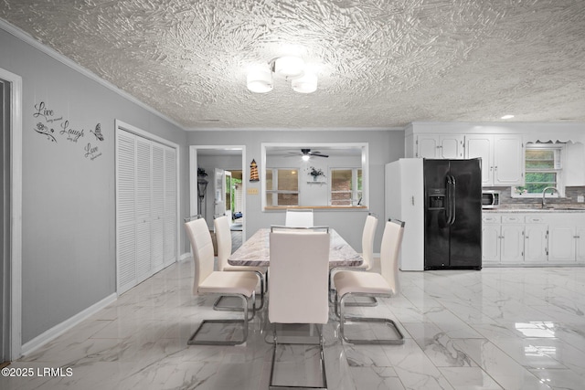 21 River Rd, Yemassee, SC 29945 - dining space with ornamental molding, light marble finish floors, and a ceiling fan