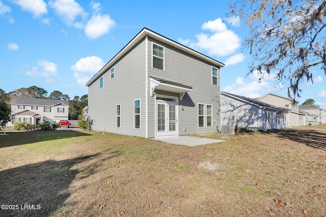 back of house featuring a yard, a patio area, and central air condition unit