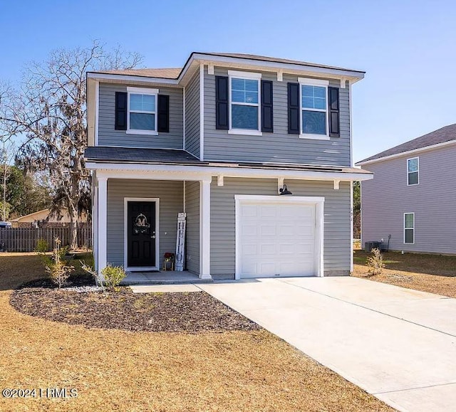 front of property featuring a garage and central air condition unit