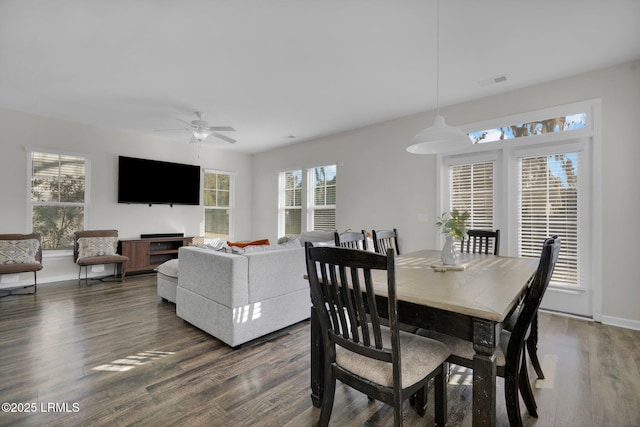 dining room with dark wood-type flooring and ceiling fan