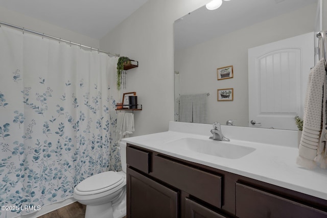 bathroom with vanity, hardwood / wood-style floors, and toilet