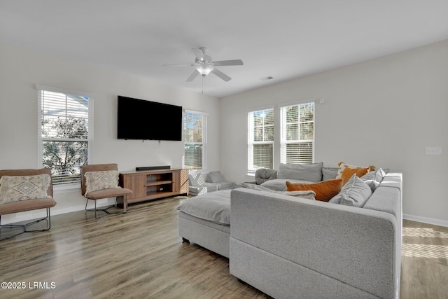 living room featuring ceiling fan, plenty of natural light, and hardwood / wood-style floors