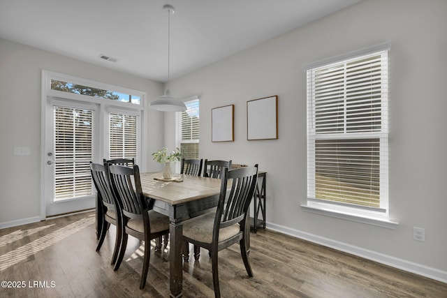 dining space with dark hardwood / wood-style floors