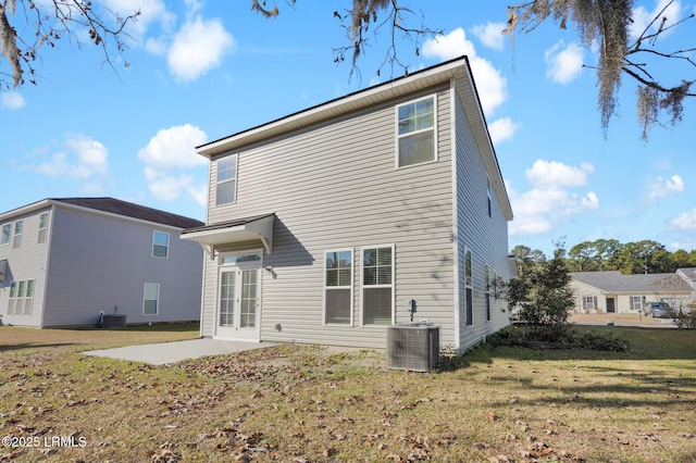 back of property featuring a lawn, central AC unit, and a patio area