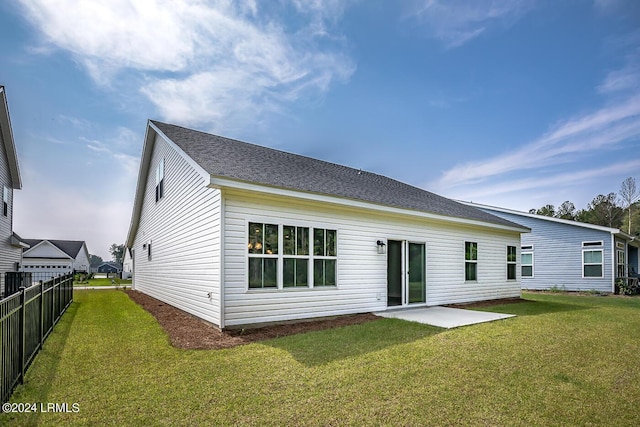 rear view of property with a lawn and a patio area