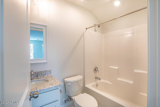 full bathroom with vanity, vaulted ceiling,  shower combination, and toilet