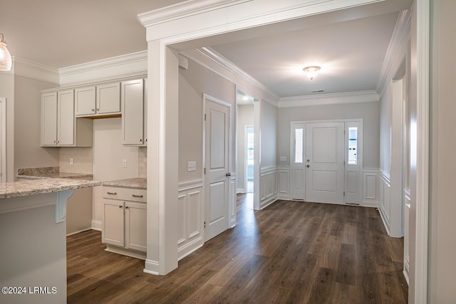 entryway featuring ornamental molding and dark wood-type flooring