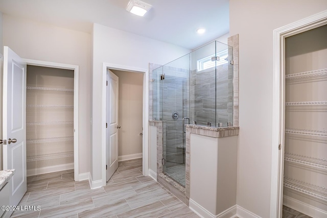 bathroom with a shower with door