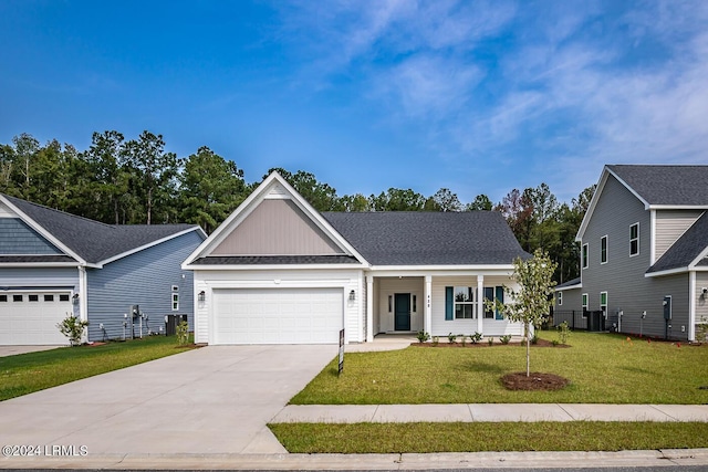 view of front of home with a porch, a garage, and a front yard