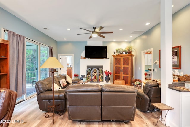 living room featuring ceiling fan and light hardwood / wood-style floors