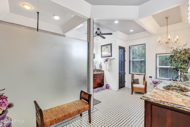 bathroom featuring beamed ceiling, vanity, and ceiling fan with notable chandelier