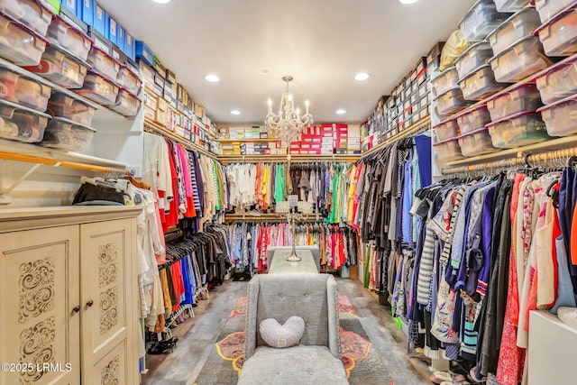 spacious closet with an inviting chandelier