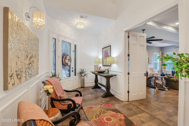 entryway featuring dark hardwood / wood-style floors and ceiling fan with notable chandelier