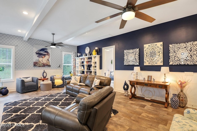 living room featuring ceiling fan, beam ceiling, and hardwood / wood-style floors